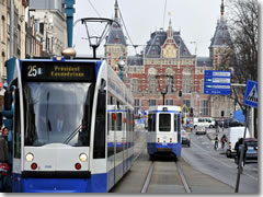 Amsterdam trams headed down the Damrack from Centraal Station.