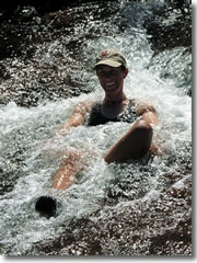 Trekking guide Jen cools off in a rushing stream.