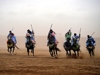 Berbers charge during a fantasia at the moussem de Tan-Tan, Morocco.