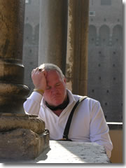 A tourist takes a catnap in the midst of visiting Milan's Castello Sforzesco.