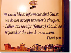 These days, businesses go out of their way to avoid getting traveler's checks—inlcuding this Italian hotel, but also (in my experience) even banks, who will either refuse to cash checks for non-clients, or will limit the amount you can change at a time to somethgin ludicrously small like $100..