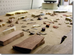 Slivers of wood waiting to be included in an intarsia wood inlay scene.