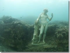 A staute under the bay forms park of Baia's underwater archeological park