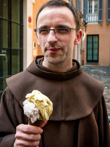 A priest enjoying a cone from gelateria Caffe Giolitti ice cream parlor, Rome