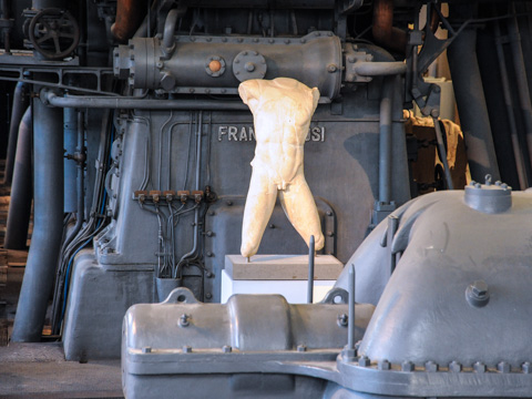 The ancient statues in Art Center Acea are posed against the industrial machinery of the Centrale Montamartini power plant