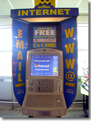 A public internet point in an airport; accepts credit cards and cash (U.S. coins, Euros, pounds, Yen, etc.)