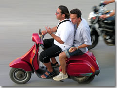 Italians talk with their hands even when their hands should be doing other, more important things, like (a) steering your scooter, and (b) hanging on to your friend who isn't steering very well.