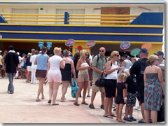 Cruise passengers flocking to the shore excursion guides.