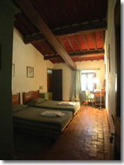 A country-comfy room at La Rignana, an agriturismo in Tuscany's Chianti region.
