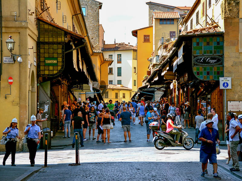 The shops lining both sides (plus the Corridorio Vasariano above on the left) make it hard to tell that Florence's Ponte Vecchio is actually a bridge. (Photo by Crash Test Mike)