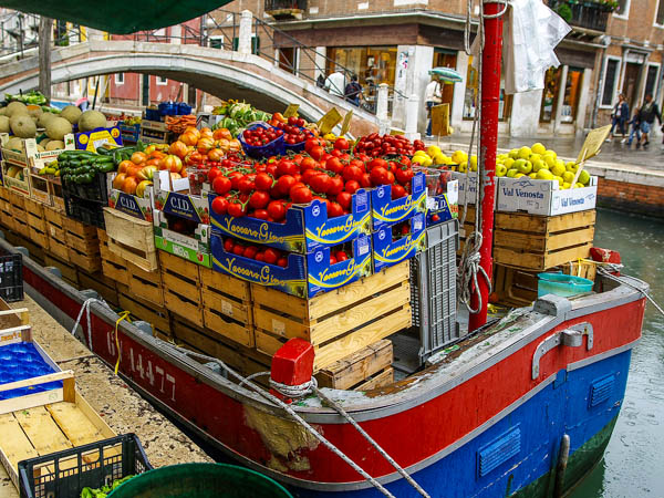 The fruit and vegetable stand on a produce barge moored in a Venice canal. (Photo by SunToad)